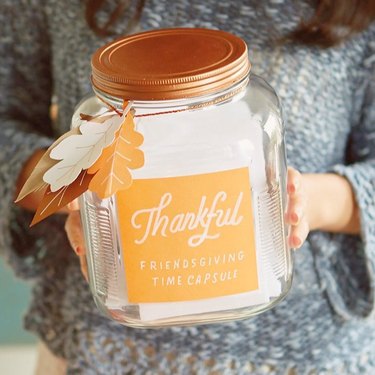 Clear jar with an orange label reading "Thankful Friendsgiving Time Capsule"