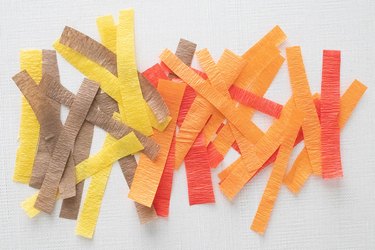 Strips of brown, yellow, orange and red crepe paper
