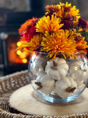 completed fall floral centerpiece in front of woodstove