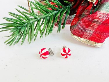 Stud earrings shaped like red and white peppermints