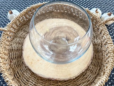 round glass vase with on top of wood base