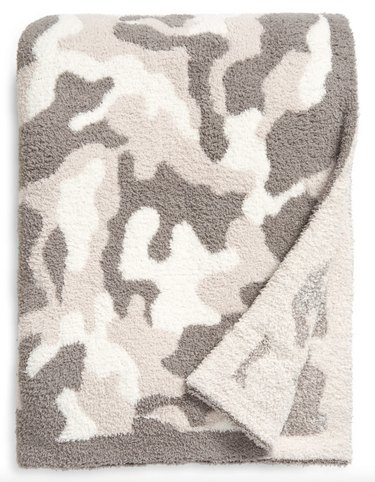 Neutral camo-print Barefoot Dreams throw blanket that's machine-washable and generous in size.