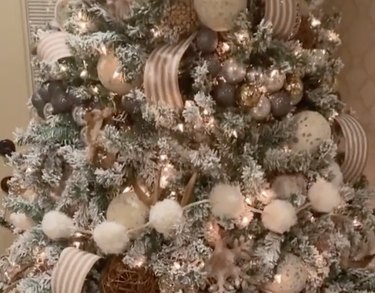 Close-up of white tree decorated with woodland-themed decor