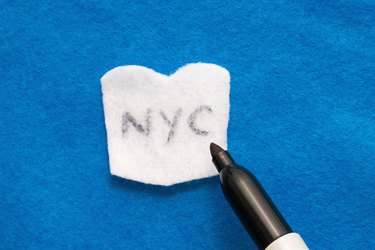 Write "NYC" on white felt for coffee cup ornament