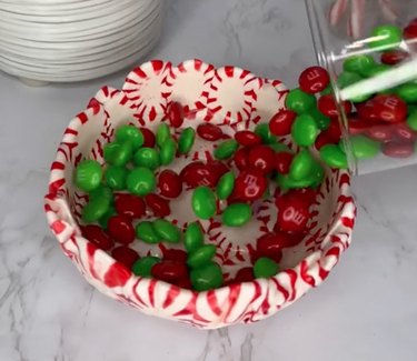 M&M's being poured into bowl made from real peppermint candies