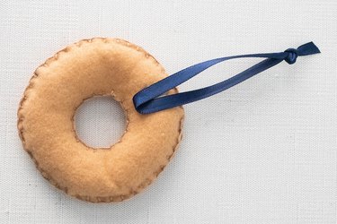 Add ribbon to DIY felt bagel ornament