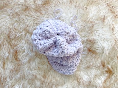The top of a crochet beanie, showing the cinched stitch.