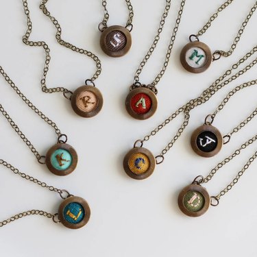 Necklaces with embroidered pendants featuring individual initials
