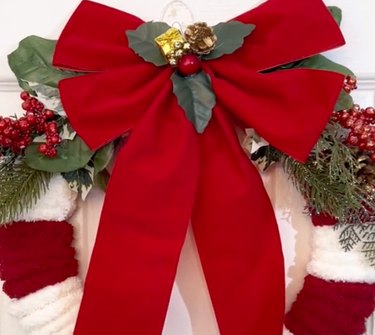 Red and white striped wreath with red bow