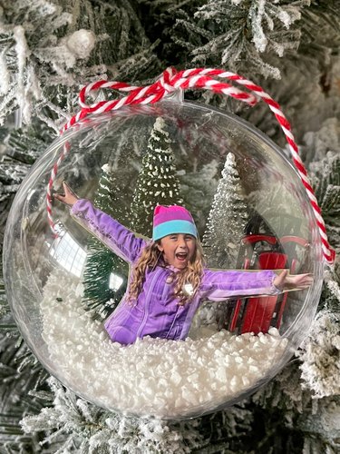 finished snow globe ornament on Christmas tree