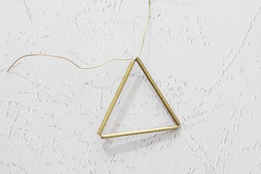 Twist the wire together to create a triangle