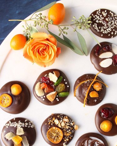 Chocolate circles topped with nuts, fruit, seeds and more