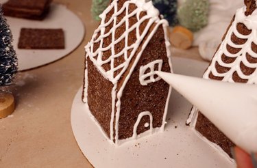 Piping a window onto graham cracker house
