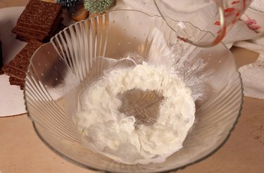 Pouring water into a mixing bowl with meringue powder