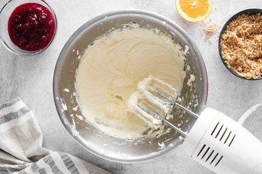 Mixing cheesecake filling with electric beater