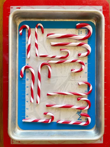 A baking sheet with red and white polymer clay candy canes.