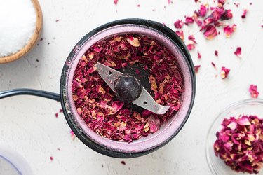 Dried rose petals in a coffee grinder