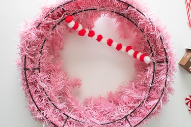 Tie pompom garland on pink wreath