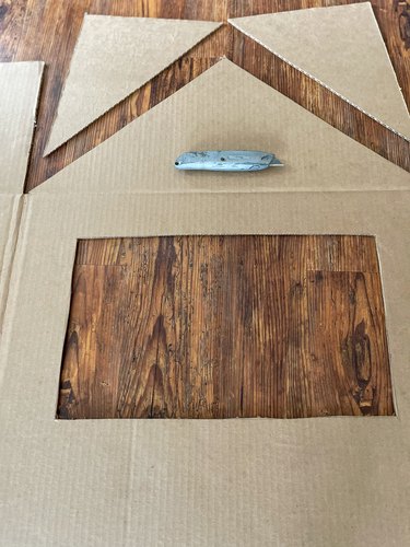 Cut out window and cut triangle roof on flap of large side of box