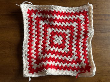 A large red and white granny square with 19 rows