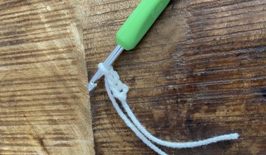 White yarn crochet chain with a green hook