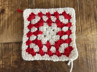A red and white crochet granny square
