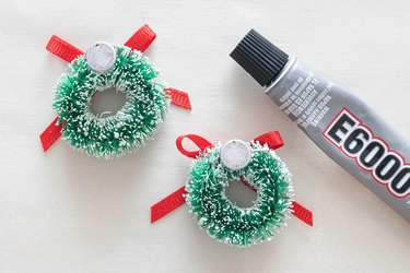 Glue charms to back of mini Christmas wreaths