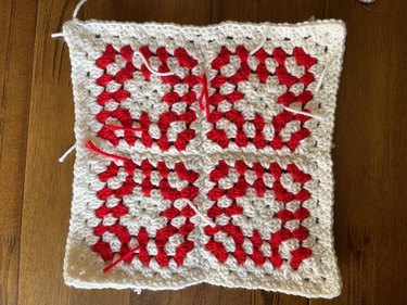 Red and white granny squares with a white crochet border