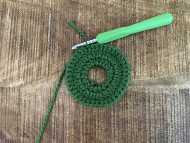 A green crochet wreath applique