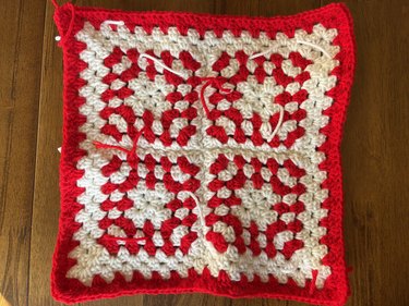 Red and white crochet granny squares with a red and white crochet border