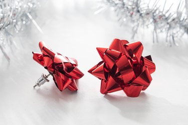 Mini gift bow earrings on a white background