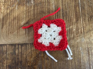 A white and red crochet granny square