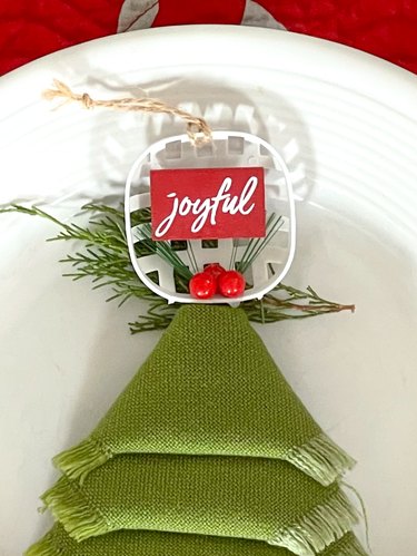add greenery and an ornament at the top