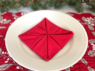 fold newly formed corners into the center of the napkin again