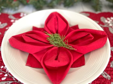 add some greenery to the center of the poinsettia napkin