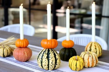 Fall candle holders with gourds and pumpkins.