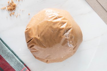 Gingerbread cookie dough wrapped in plastic wrap