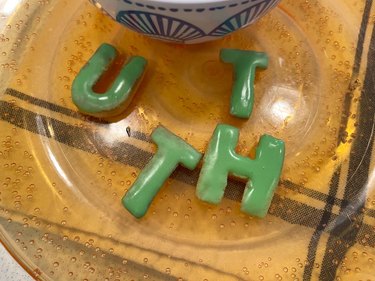 Alphabet cookies with royal icing  on plate