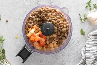 Vegan chickpea and lentil meatloaf ingredients in a food processor