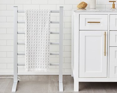 Freestanding electric towel rack next to vanity