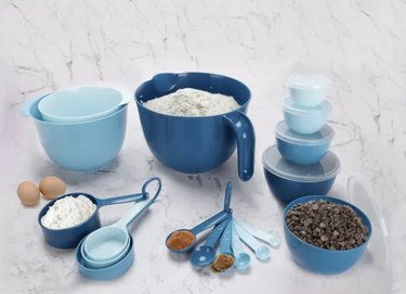 Mixing bowl set in blue that includes 23 pieces such as measuring cups, measuring spoons, mixing bowls and prep bowls with lids.