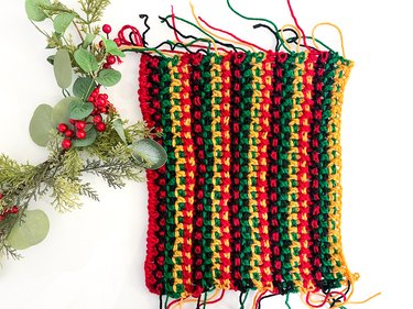 Fifth set of four crocheted rows in red, black, green and yellow