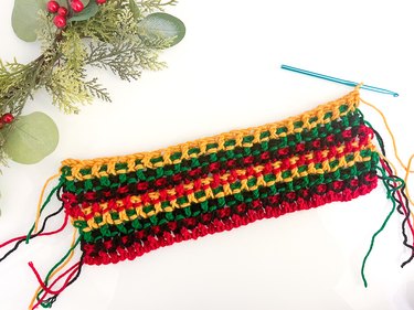 Second set of four crocheted rows in red, black, green and yellow repeating