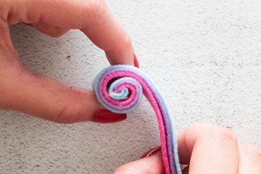 Rolling strips of felt together