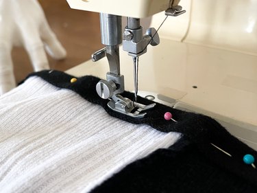 pin and sew knit trim onto raw edges of sleeves