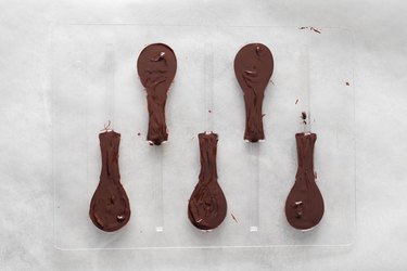 Tennis racket mold filled with melted chocolate