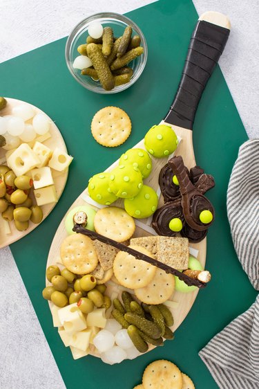 Pickleball charcuterie board on a green background