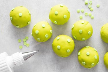 Pickleball truffles with bright green fondant and sprinkles