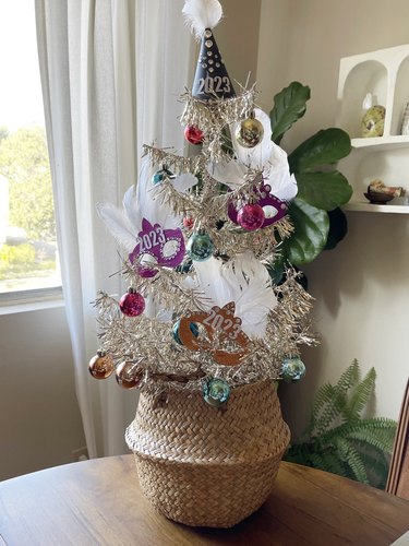 A New Year's Eve tree made from tinsel, ornaments and 2023-themed decor.