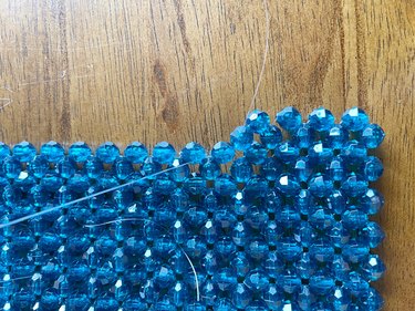 A closeup of a beaded bag in the making, showing how to attach a new row.